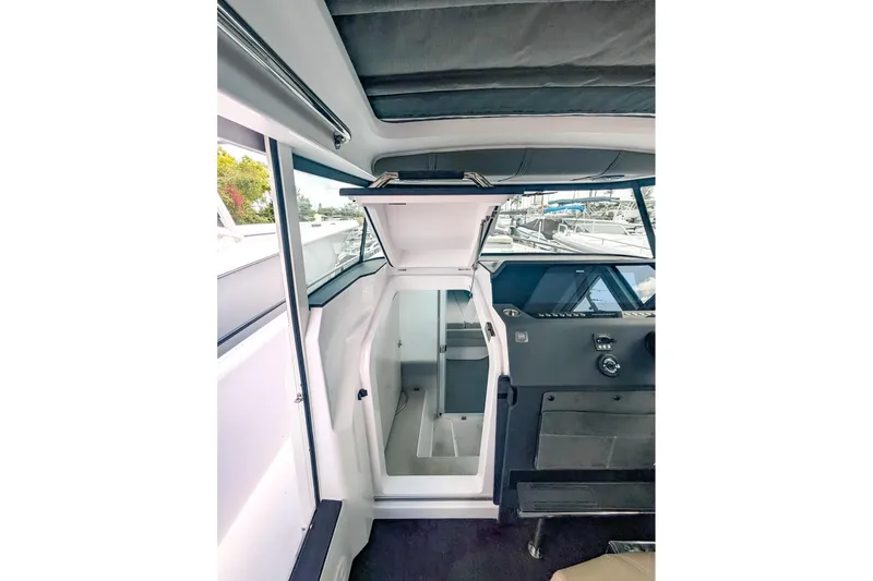  Yacht Photos Pics Interior of 2024 Axopar 37XC CROSS CABIN BRABUS Trim, showcasing helm and cabin entrance.