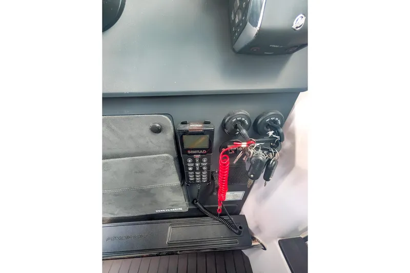  Yacht Photos Pics 2024 Axopar 37XC CROSS CABIN BRABUS Trim dashboard with Simrad radio and ignition keys.