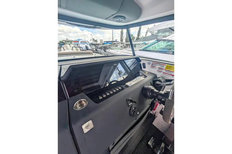  Yacht Photos Pics 2024 Axopar 37XC CROSS CABIN BRABUS Trim dashboard with modern controls and steering.