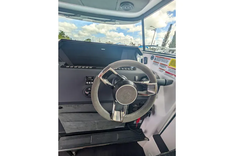  Yacht Photos Pics 2024 Axopar 37XC CROSS CABIN BRABUS Trim steering wheel and dashboard view.