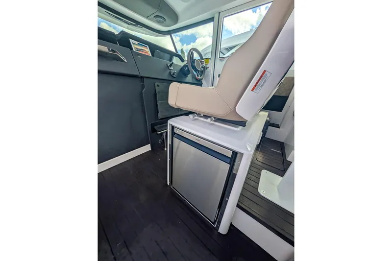  Yacht Photos Pics 2024 Axopar 37XC CROSS CABIN BRABUS interior with helm seat and compact fridge.