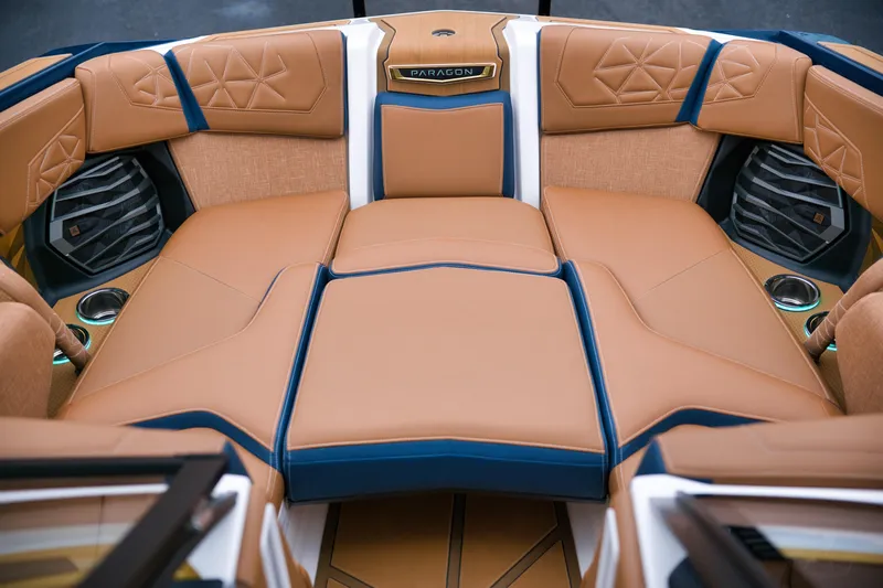  Yacht Photos Pics 2024 Nautique Super Air Nautique G23 Paragon interior with luxurious tan and blue seating.