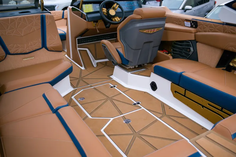  Yacht Photos Pics 2024 Nautique Super Air Nautique G23 Paragon interior with luxurious tan and blue seating.