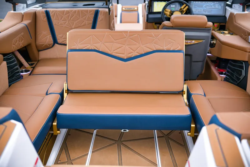  Yacht Photos Pics 2024 Nautique Super Air Nautique G23 Paragon interior with luxurious tan and blue seating.