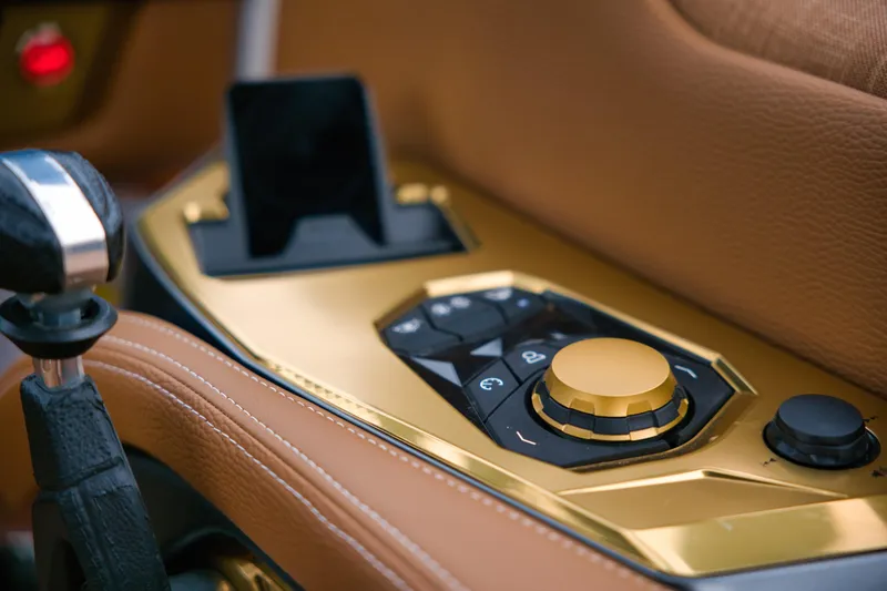  Yacht Photos Pics 2024 Nautique Super Air Nautique G23 Paragon control panel with gold accents and leather trim.