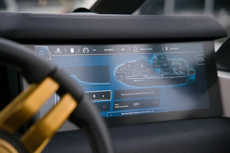  Yacht Photos Pics 2024 Nautique Super Air Nautique G23 Paragon dashboard with digital display and steering wheel.