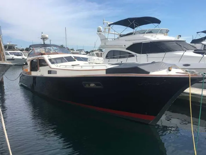 Blackjack Yacht Photos Pics 1984 Midnight Lace Rumrunner yacht docked in marina, surrounded by other boats.