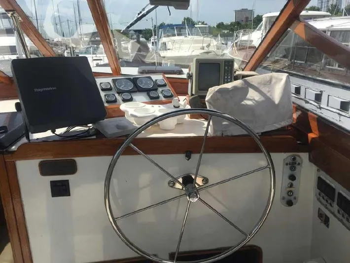 Blackjack Yacht Photos Pics 1984 Midnight Lace Rumrunner boat helm with steering wheel and navigation equipment.