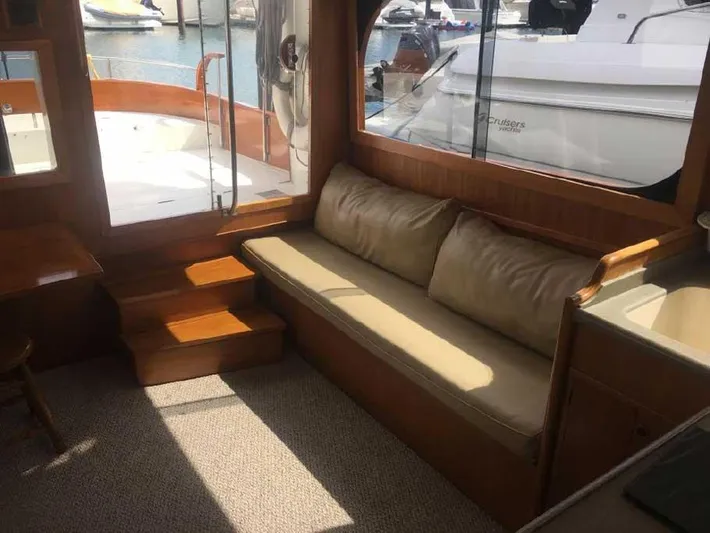 Blackjack Yacht Photos Pics 1984 Midnight Lace Rumrunner yacht interior with beige seating and wooden accents.
