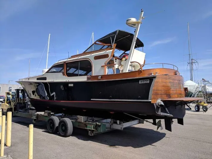 Blackjack Yacht Photos Pics 1984 Midnight Lace Rumrunner boat on trailer, showcasing classic design and wooden accents.