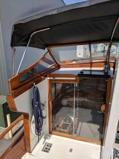 Blackjack Yacht Photos Pics 1984 Midnight Lace Rumrunner boat cockpit with canopy and wooden accents.