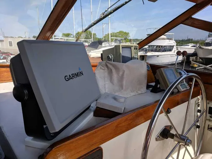 Blackjack Yacht Photos Pics 1984 Midnight Lace Rumrunner boat cockpit with Garmin navigation system and steering wheel.