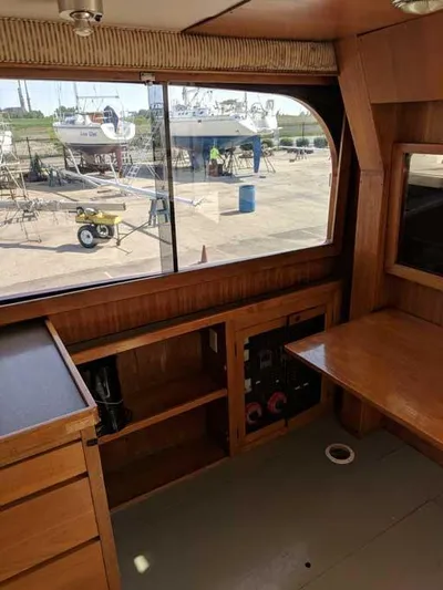 Blackjack Yacht Photos Pics Interior of 1984 Midnight Lace Rumrunner boat with wooden cabinetry and large window.