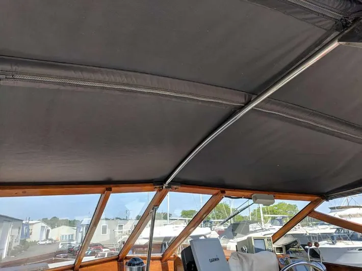 Blackjack Yacht Photos Pics 1984 Midnight Lace Rumrunner boat interior with canopy and marina view.