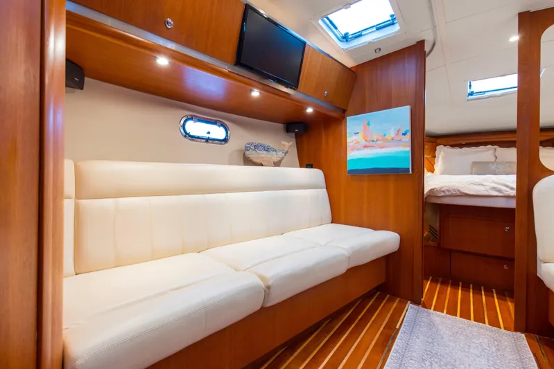 Forever Friday Yacht Photos Pics Luxurious interior of 2005 Tiara Yachts 3600 Sovran with white seating and wood accents.