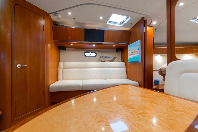 Forever Friday Yacht Photos Pics Interior of 2005 Tiara Yachts 3600 Sovran with wood finish and white seating.