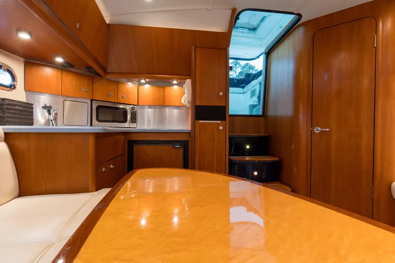 Forever Friday Yacht Photos Pics Interior of 2005 Tiara Yachts 3600 Sovran, featuring a modern kitchen and dining area.