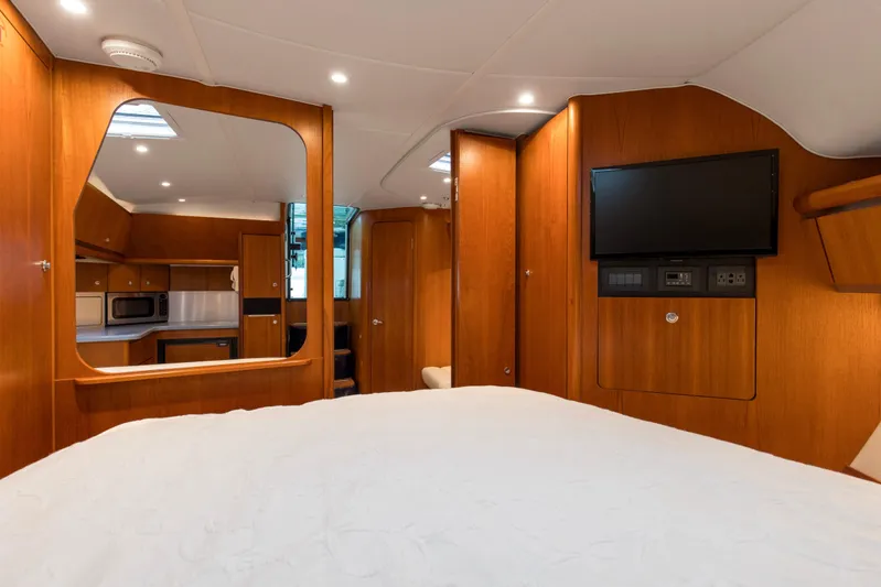 Forever Friday Yacht Photos Pics Interior of 2005 Tiara Yachts 3600 Sovran, featuring wood paneling, bed, and mounted TV.
