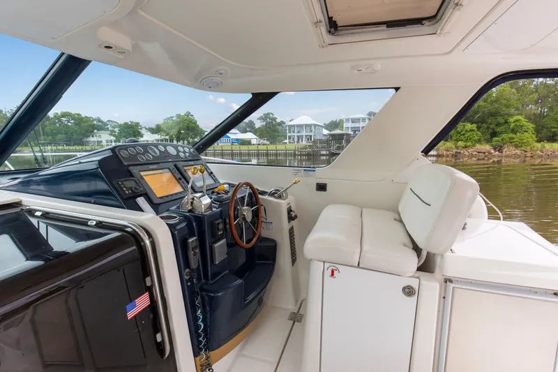 Forever Friday Yacht Photos Pics 2005 Tiara Yachts 3600 Sovran helm with modern controls and comfortable seating.