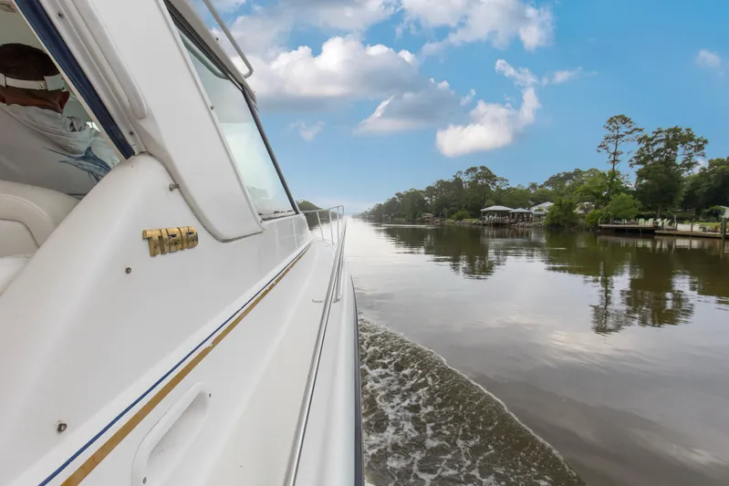 Forever Friday Yacht Photos Pics 2005 Tiara Yachts 3600 Sovran cruising on a serene river under a blue sky.