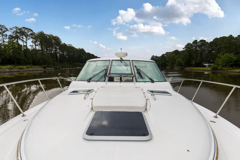 Forever Friday Yacht Photos Pics 2005 Tiara Yachts 3600 Sovran cruising on a serene river under a blue sky.