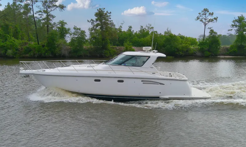 Forever Friday Yacht Photos Pics 2005 Tiara Yachts 3600 Sovran cruising on a calm river with lush greenery.