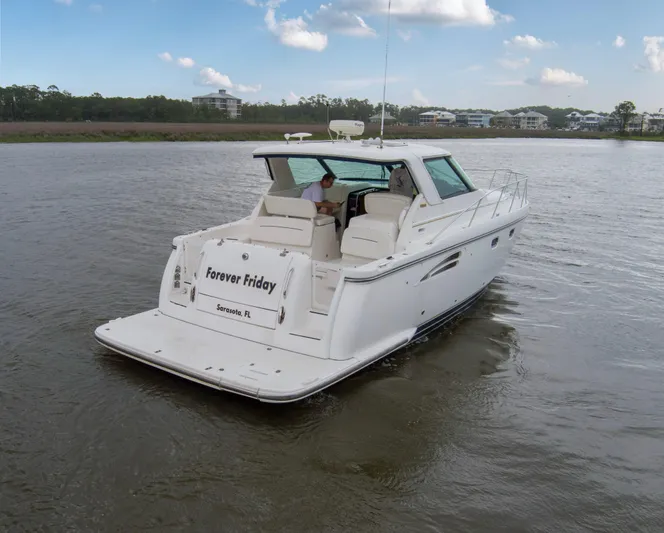Forever Friday Yacht Photos Pics 2005 Tiara Yachts 3600 Sovran cruising on a calm river under a blue sky.