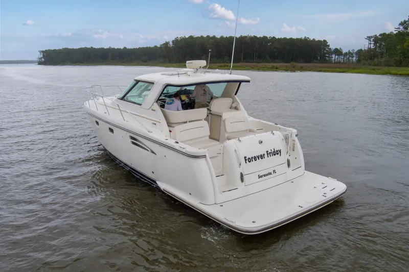 Forever Friday Yacht Photos Pics 2005 Tiara Yachts 3600 Sovran cruising on a calm river, rear view.