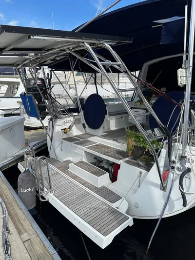 Lucky Yacht Photos Pics Beneteau Oceanis 45 sailboat, 2014 model, docked with open transom and blue canopy.