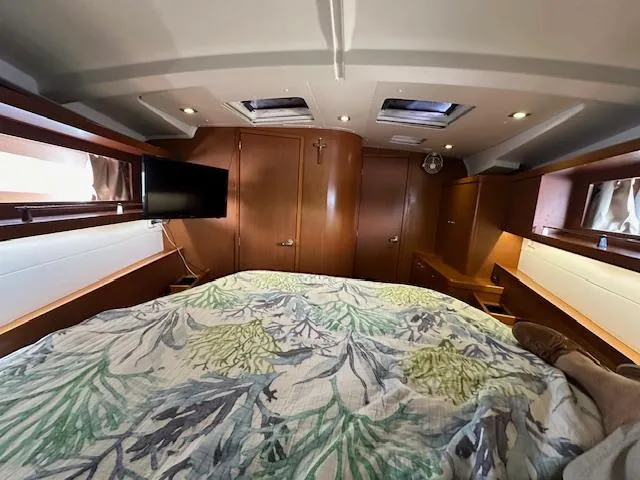 Lucky Yacht Photos Pics Interior cabin of 2014 Beneteau Oceanis 45 yacht with cozy bedding and modern amenities.