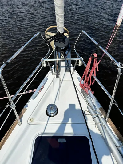 Lucky Yacht Photos Pics Bow view of 2014 Beneteau Oceanis 45 sailboat with ropes and railing.