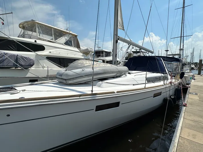 Lucky Yacht Photos Pics 2014 Beneteau Oceanis 45 sailboat docked at marina under clear sky.