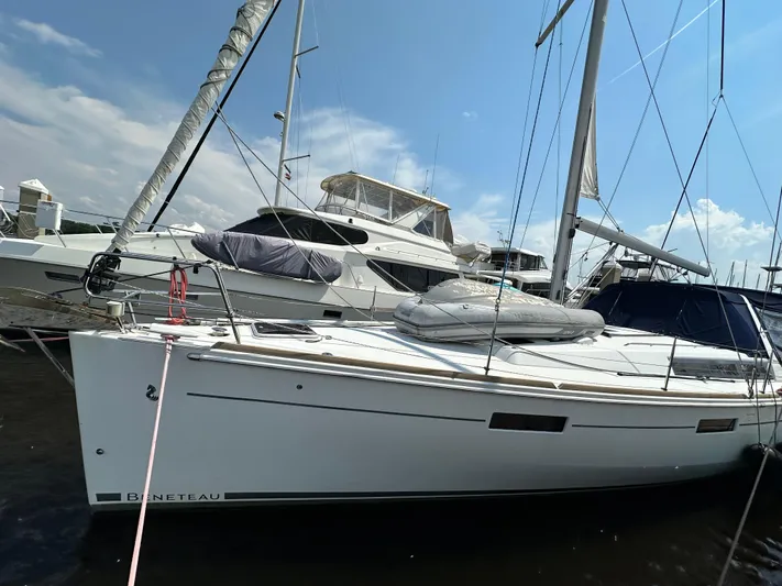 Lucky Yacht Photos Pics 2014 Beneteau Oceanis 45 sailboat docked under a clear blue sky.