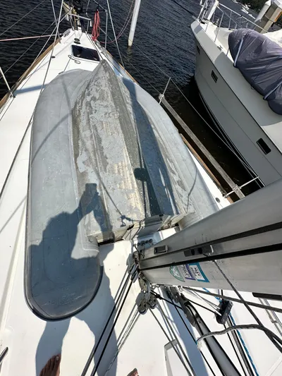 Lucky Yacht Photos Pics Beneteau Oceanis 45 sailboat deck with dinghy, 2014 model, docked at marina.