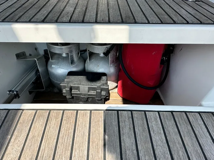 Lucky Yacht Photos Pics Storage compartment on a 2014 Beneteau Oceanis 45 sailboat with gas cylinders and equipment.