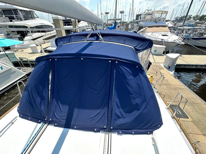 Lucky Yacht Photos Pics Beneteau Oceanis 45 sailboat, 2014 model, with blue canvas cover docked at marina.