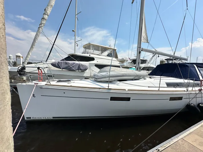 Lucky Yacht Photos Pics 2014 Beneteau Oceanis 45 sailboat docked at marina under clear blue sky.