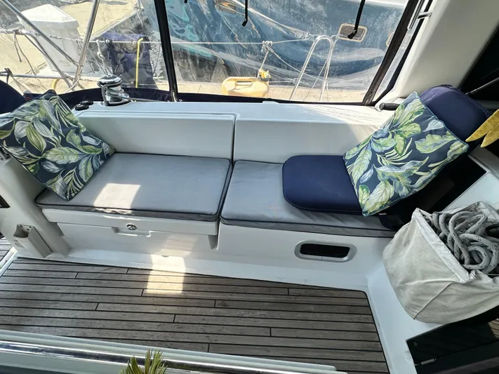 Lucky Yacht Photos Pics Cozy seating area on a 2014 Beneteau Oceanis 45 sailboat with leaf-patterned cushions.