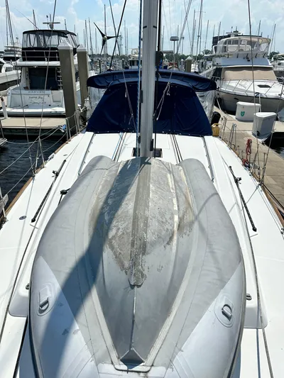 Lucky Yacht Photos Pics 2014 Beneteau Oceanis 45 sailboat docked, featuring a dinghy on deck.