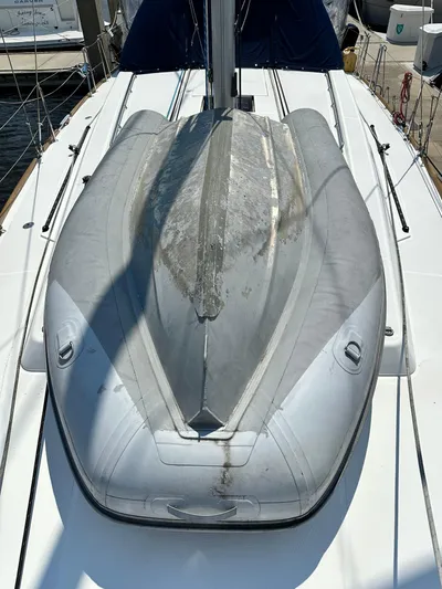 Lucky Yacht Photos Pics 2014 Beneteau Oceanis 45 sailboat deck with an inflatable dinghy secured on top.
