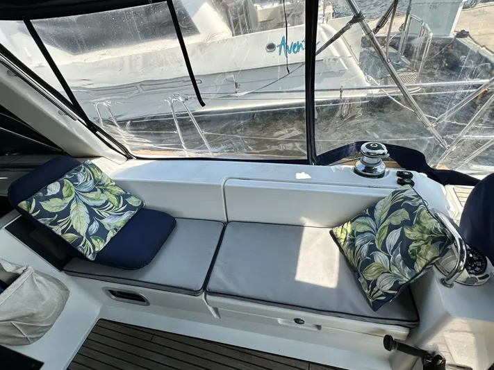 Lucky Yacht Photos Pics Cozy seating area on 2014 Beneteau Oceanis 45 sailboat with leaf-patterned cushions.