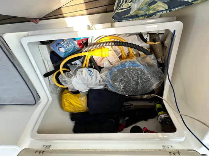 Lucky Yacht Photos Pics Storage compartment on a 2014 Beneteau Oceanis 45 yacht, filled with marine equipment.