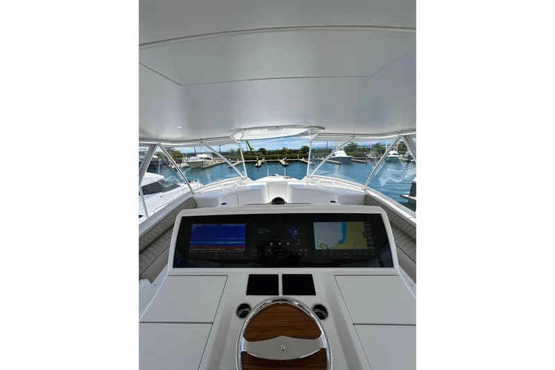Boujie Yacht Photos Pics Interior view of 2025 Viking 82 Convertible yacht cockpit with navigation screens.