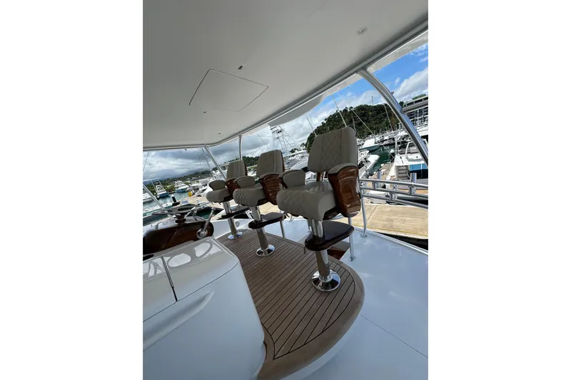 Boujie Yacht Photos Pics Luxurious 2025 Viking 82 Convertible yacht interior with elegant seating and marina view.