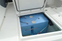 Open storage compartment on a 2017 Leopard 45 boat showing a blue water tank.