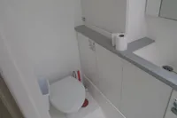 Compact bathroom in a 2017 Leopard 45 yacht with toilet and sink.