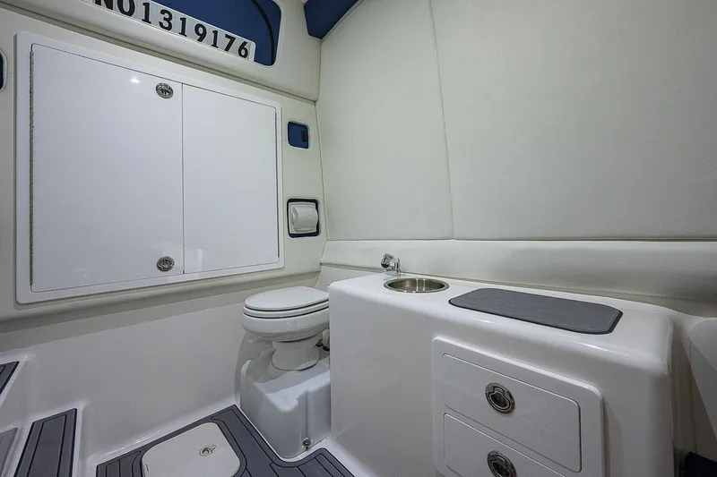 Bluefin Tales Yacht Photos Pics 2021 Front Runner 39 Center Console boat interior with toilet and sink.