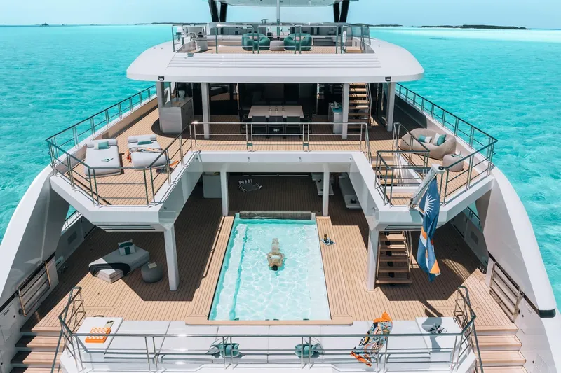 Reduce Yacht Photos Pics Luxurious 2024 Silver Yachts SilverCat 36M yacht with pool, cruising in turquoise waters.