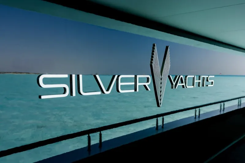 Reduce Yacht Photos Pics Silver Yachts logo on SilverCat 36M, 2024 model, with ocean backdrop.