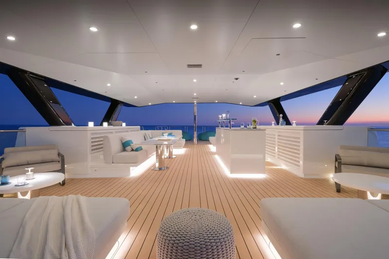 Reduce Yacht Photos Pics Luxurious deck of 2024 Silver Yachts SilverCat 36M at sunset, featuring elegant seating and ambient lighting.